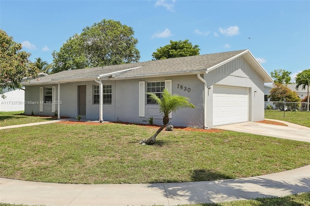 single story home featuring a garage and a front lawn