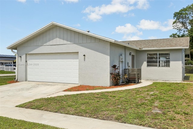 view of front of home with a garage and a front lawn