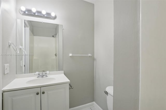 bathroom featuring vanity, a shower, and toilet