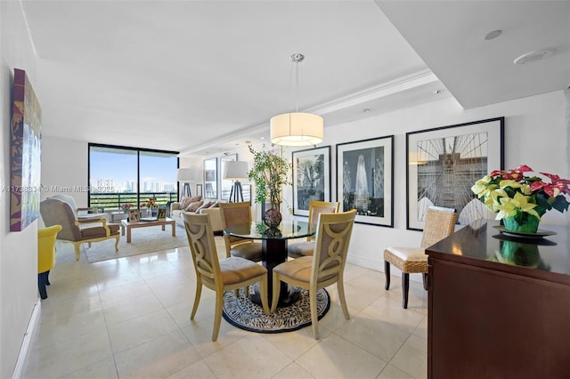 tiled dining area featuring a wall of windows