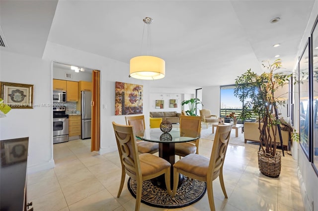 dining room featuring expansive windows and light tile patterned floors