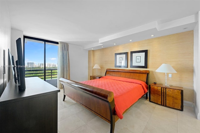 bedroom with floor to ceiling windows and access to outside