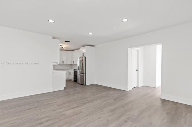 unfurnished living room with light hardwood / wood-style floors