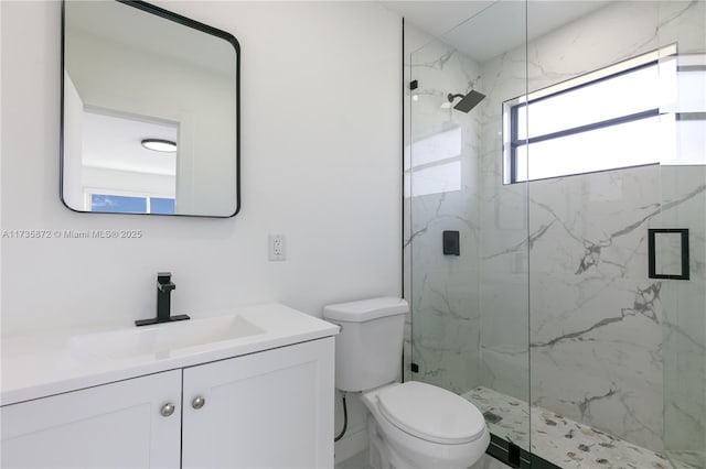 bathroom with vanity, toilet, and a shower with shower door