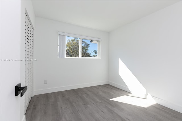 spare room featuring wood-type flooring