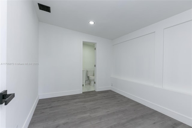 unfurnished room with hardwood / wood-style flooring