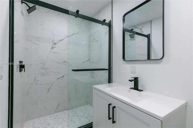 bathroom with vanity and a shower with door