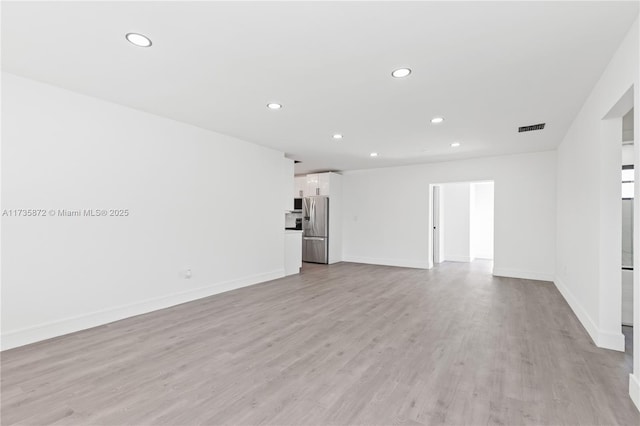 unfurnished living room featuring light hardwood / wood-style floors