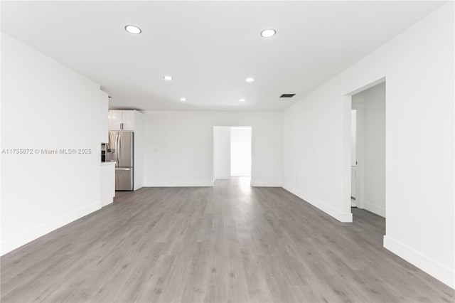 empty room with light hardwood / wood-style flooring