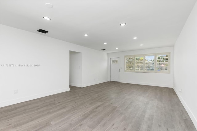 unfurnished room with light hardwood / wood-style floors