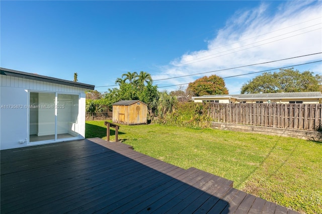 deck featuring a lawn and a storage unit