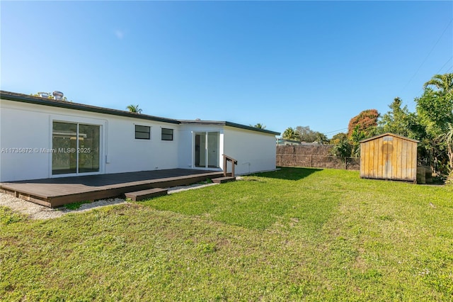 view of yard with a storage unit and a deck