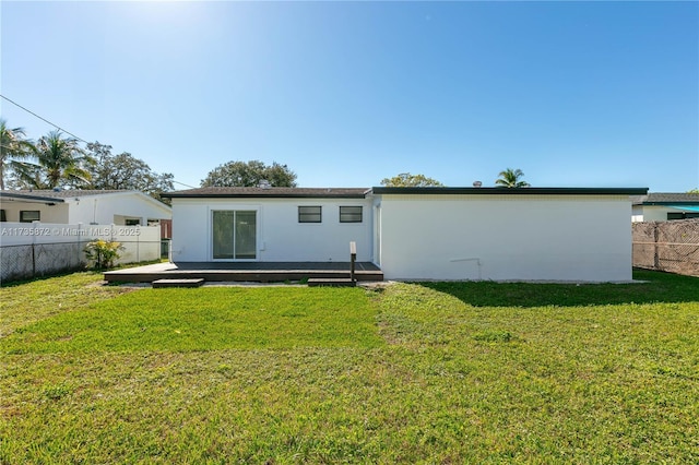 rear view of house featuring a yard