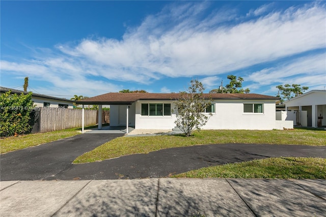 ranch-style home with a front lawn and a carport