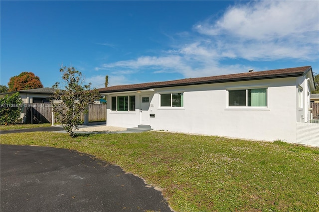 ranch-style house with a front lawn