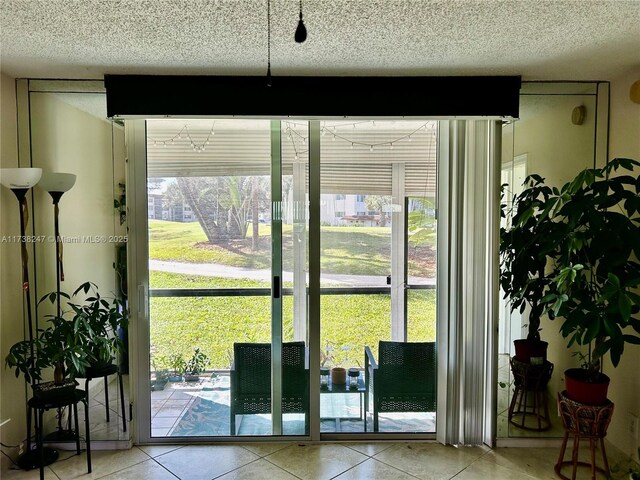 entryway featuring tile patterned floors and a textured ceiling