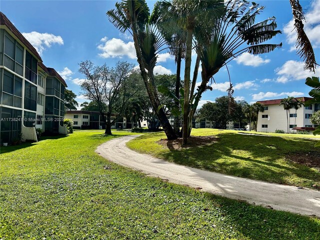 view of property's community featuring a yard