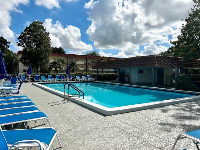 view of swimming pool with a pergola and a patio