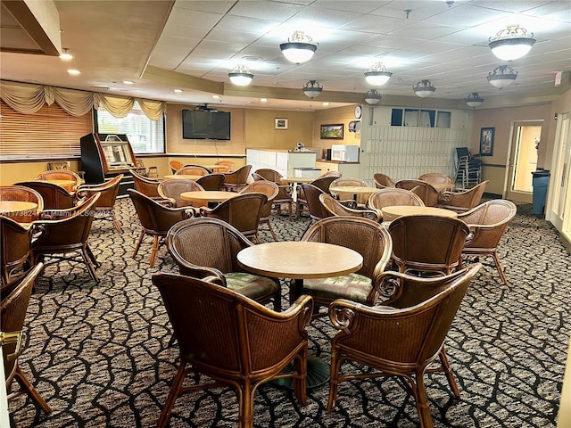 carpeted dining room with a drop ceiling