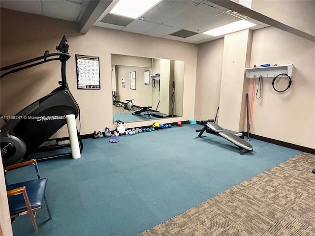 exercise room with a paneled ceiling