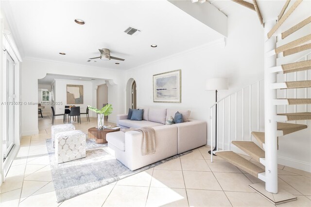 tiled living room featuring ornamental molding and ceiling fan