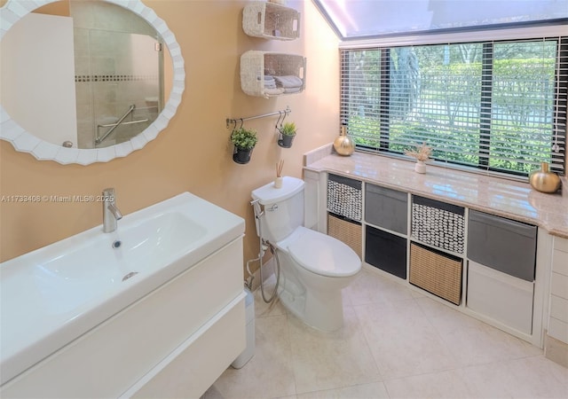 bathroom with vanity, tile patterned floors, and toilet