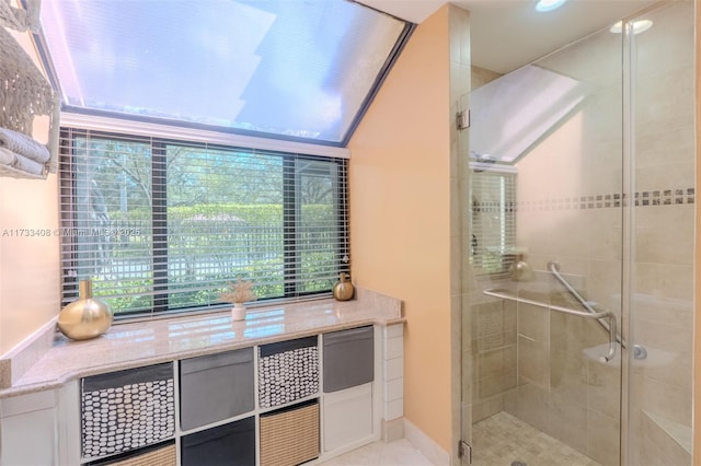 bathroom featuring a shower with shower door