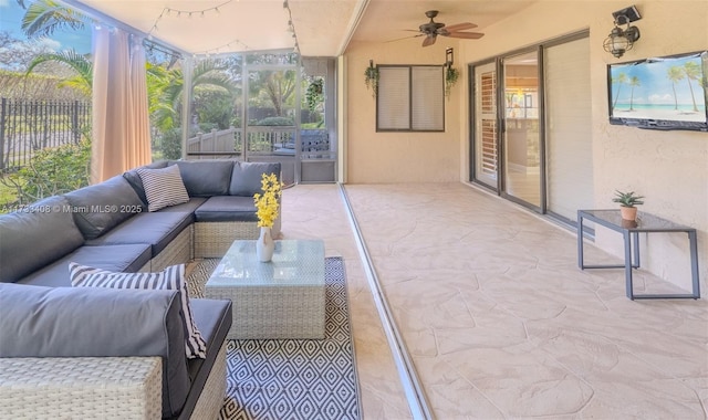 sunroom featuring ceiling fan