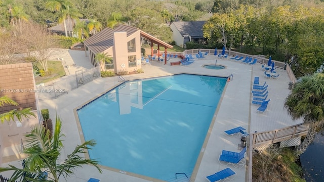 view of swimming pool with a community hot tub and a patio