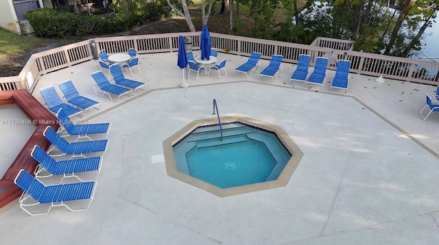 view of pool featuring a community hot tub and a patio