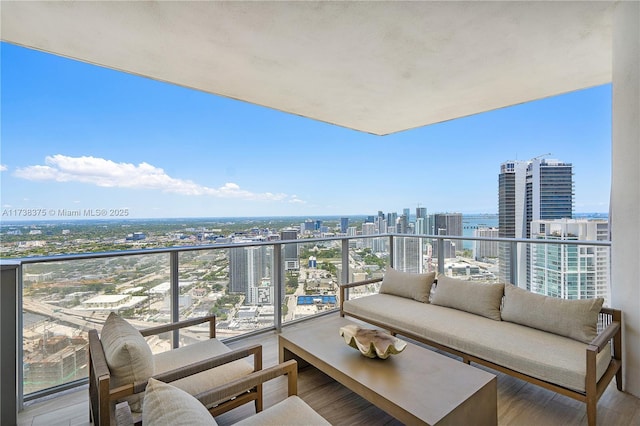 balcony with a view of city and an outdoor hangout area