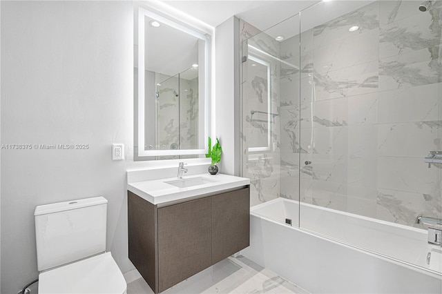 bathroom with toilet, marble finish floor,  shower combination, and vanity