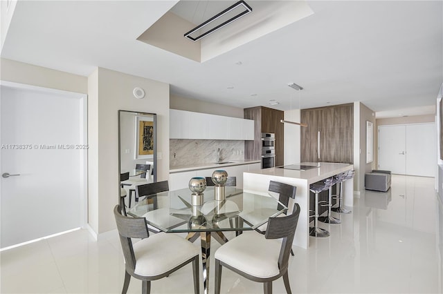 dining area featuring visible vents, baseboards, and light tile patterned floors