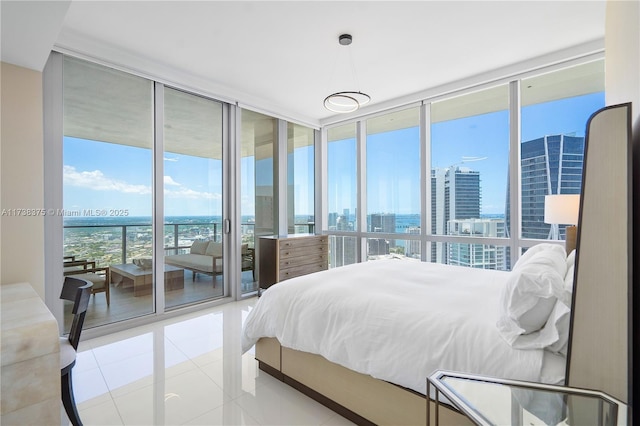 tiled bedroom with access to outside, a wall of windows, and a city view