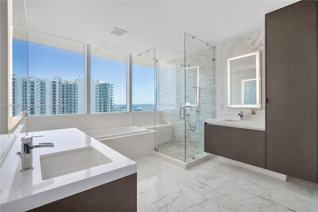 bathroom with a sink, marble finish floor, a bath, a view of city, and a stall shower