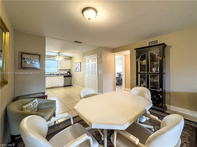 tiled dining room with ceiling fan