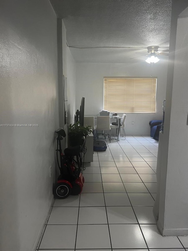 interior space with tile patterned floors and a textured ceiling