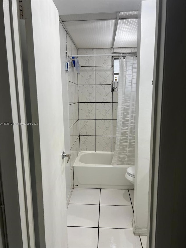 bathroom with tile patterned flooring, toilet, and shower / bathtub combination with curtain