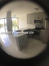 kitchen featuring stainless steel appliances, sink, and gray cabinetry