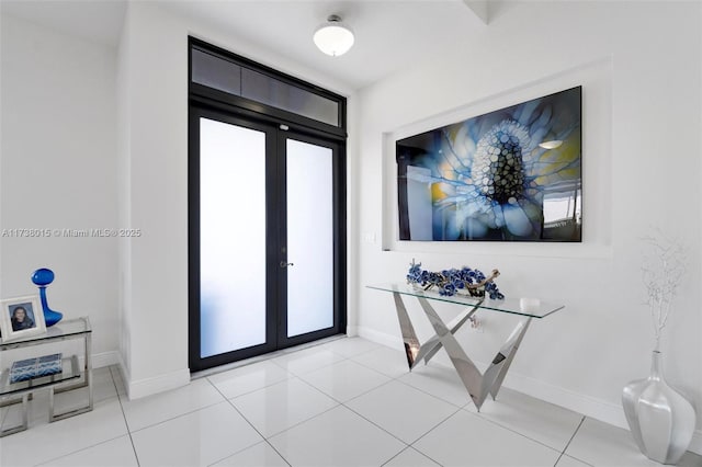 entryway with light tile patterned floors and french doors