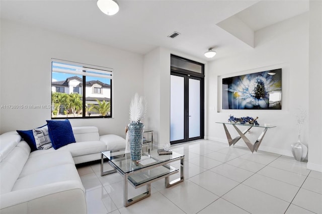 tiled living room featuring french doors