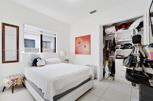 bedroom featuring light tile patterned floors and a closet