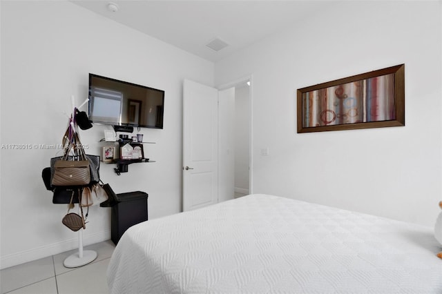 bedroom with light tile patterned floors