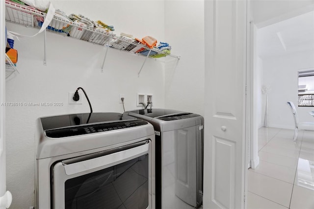 washroom with tile patterned floors and washer and dryer