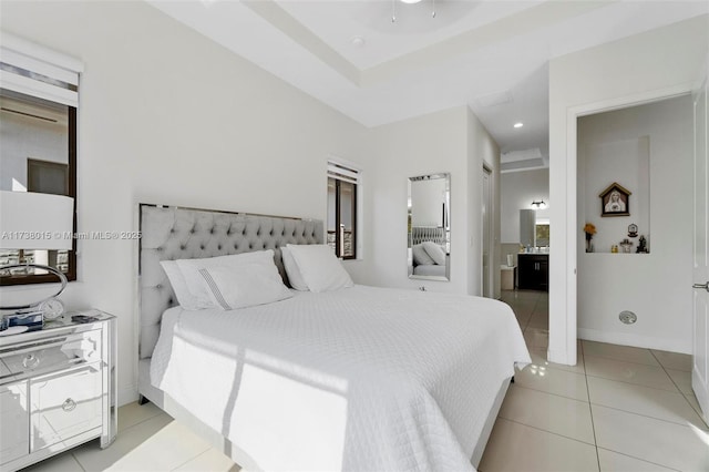 bedroom featuring ensuite bath and light tile patterned flooring