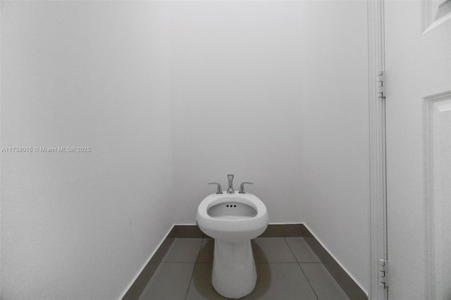 bathroom featuring tile patterned flooring and a bidet