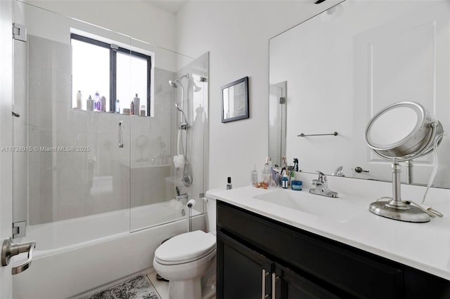 full bathroom with vanity, shower / bath combination with glass door, and toilet