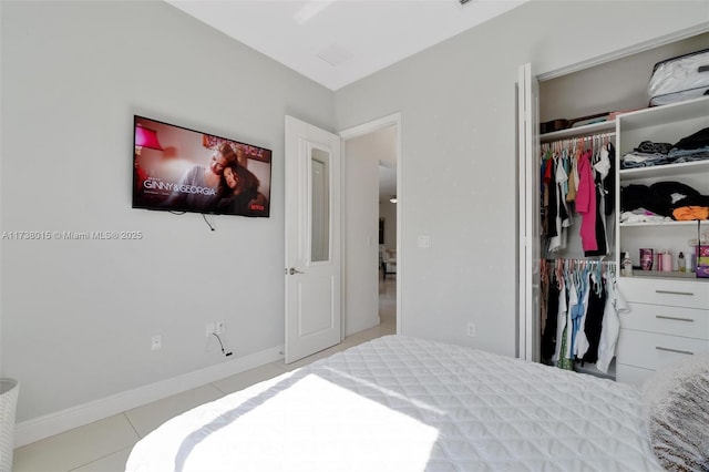 tiled bedroom with a closet