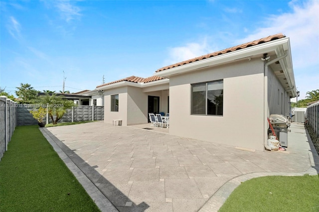 back of house with a patio