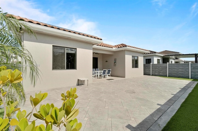 back of property with a patio and ceiling fan